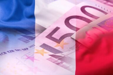 the national flags of France with euro banknotes in the background