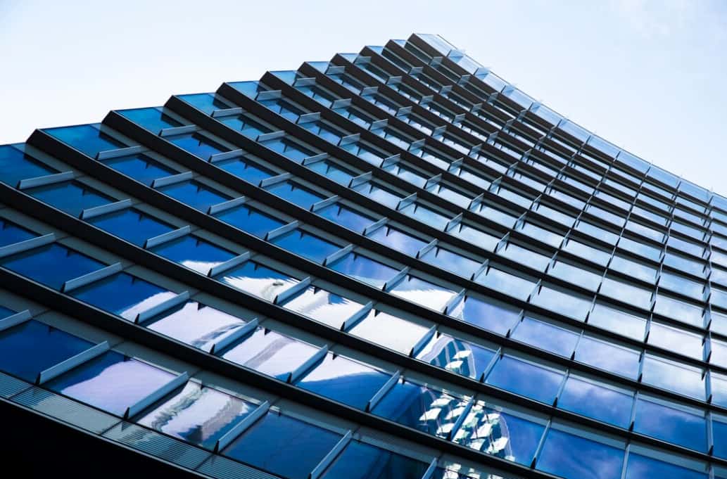 Close-up of a skyscraper's blue glass facade with angular patterns